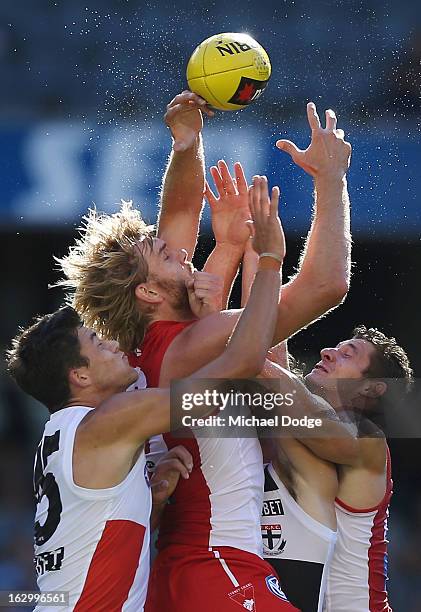 Jackson Ferguson of the St.Kilda Saints contests for the ball against Lewis Roberts-Thompson and Andrejs Everitt of the Sydney Swans during the round...