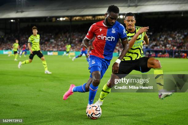 Odsonne Edouard of Crystal Palace runs with the ball under pressure from William Saliba of Arsenal during the Premier League match between Crystal...