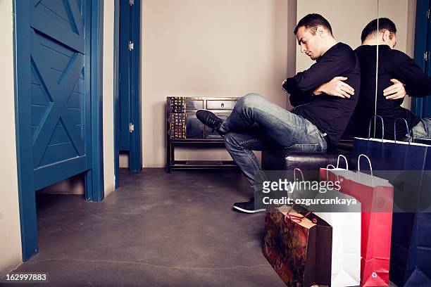 a man waiting outside of a changing room for his wife - man waiting stock pictures, royalty-free photos & images
