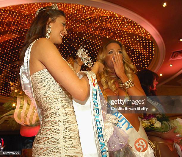 Miss TropicBeauty 2012, Ligia Hernandez congratulates Linda Zimany of Hungary as she wins the title of Miss TropicBeauty 2013 during the third annual...