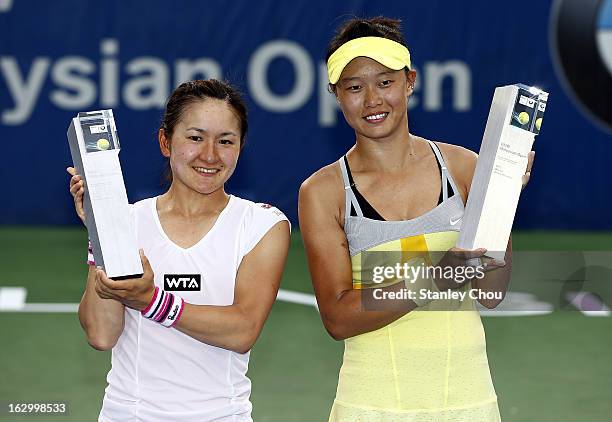 Shuko Aoyama of Japan and Kai-Chen Chang of Chinese Taipei pose with their trophies during a presentation ceremony after they defeated Janette...