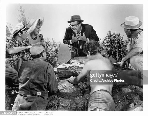 Ethel Merman, Phil Silvers and Terry Thomas find the money in a scene from the film 'It's A Mad Mad Mad Mad World', 1963.