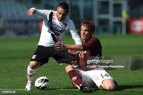 Fabrizio Miccoli of US Citta di Palermo is challenged by Alessandro Gazzi of Torino FC during the Serie A match between Torino FC and US Citta di...