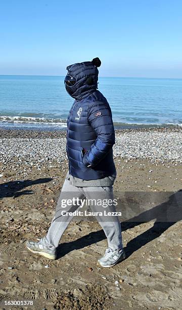 Italian comedian, blogger and political leader of the Five Stars Movement Beppe Grillo runs on the beach on March 3, 2013 in Marina di Bibbona, near...