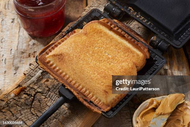 campfire peanut butter and jam sandwich - peanut butter toast stock pictures, royalty-free photos & images