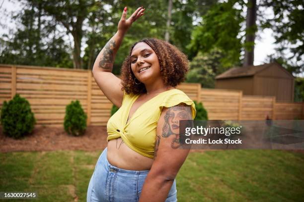 multi racial woman poses and dances in back yard - gold tooth stock pictures, royalty-free photos & images