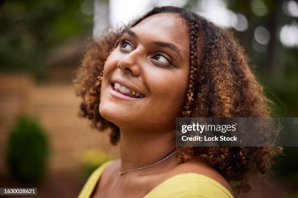 multi racial woman poses and dances in back yard - gold tooth stock pictures, royalty-free photos & images