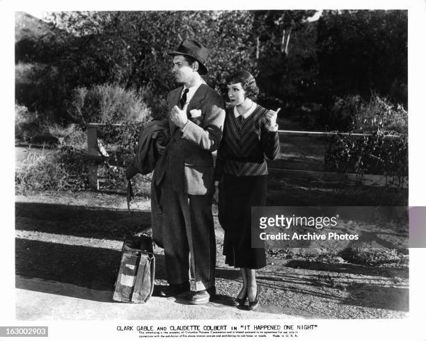 Clark Gable hitchhikes with Claudette Colbert in a scene from the film 'It Happened One Night', 1934.