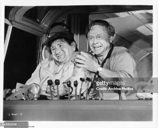 Buddy Hackett flies a plane with Mickey Rooney in a scene from the film 'It's A Mad Mad Mad Mad World', 1963.