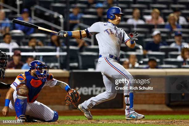 Nathaniel Lowe of the Texas Rangers hits a two-run single against the New York Mets during the ninth inning of a game at Citi Field on August 28,...