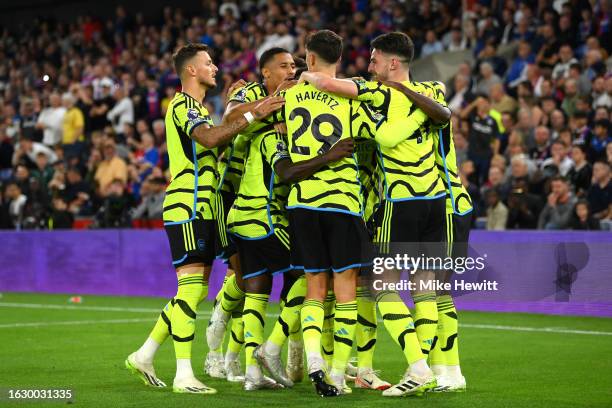 Martin Odegaard of Arsenal celebrates with teammates after scoring the team's first goal during the Premier League match between Crystal Palace and...