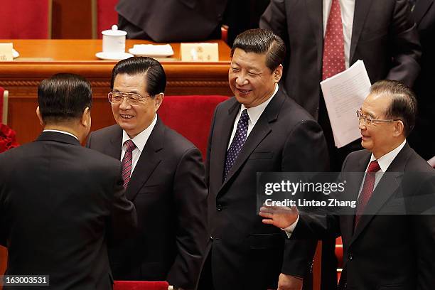 Jia Qinglin, Chairman of the National Committee of the Chinese People's Political Consultative Conference shakes hands Chinese President Hu Jintao,...
