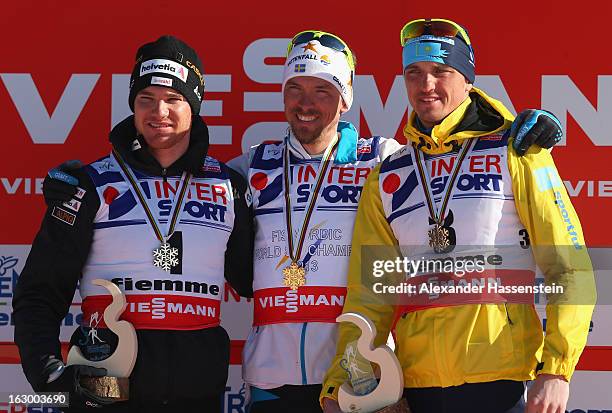 Johan Olsson of Sweden poses with his Gold medal, Dario Cologna of Switzerland his Silver medal and Alexey Poltoranin of Kazakhstan his Bronze medal...