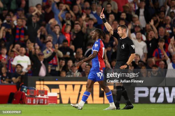 Match Referee David Coote shows a red card to Takehiro Tomiyasu of Arsenal during the Premier League match between Crystal Palace and Arsenal FC at...