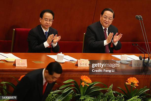 Delegate Ling Jihua and Yu Zhengsheng applaud as Chairman of the Chinese People's Political Consultative Conference Jia Qinglin bowing during the...