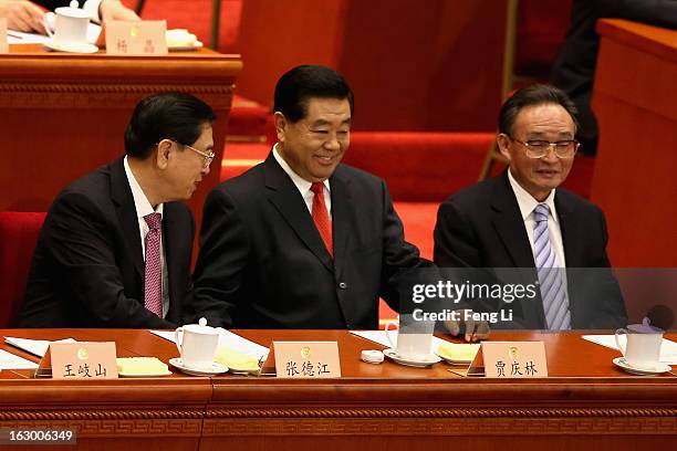 Jia Qinglin , chairman of the Chinese People's Political Consultative Conference, reacts after delivering a speech at the opening session of the...
