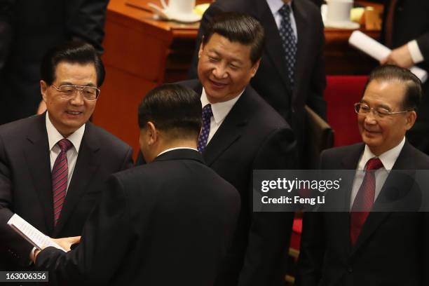 China's President Hu Jintao shakes hands with Chairman of the Chinese People's Political Consultative Conference Jia Qinglin as China's Communist...