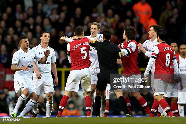 Opposing captains Thomas Vermaelen of Arsenal and Michael Dawson of Spurs clash during the Barclays Premier League match between Tottenham Hotspur...