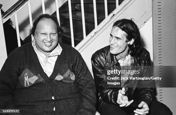 Pakistani musician Nusrat Fateh Ali Khan shares a laugh with American musician Jeff Buckley backstage after Khan's World Music Institute concert at...