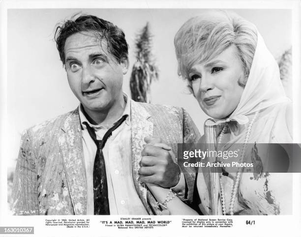 Sid Caesar holds hands with Dorothy Provine in a scene from the film 'It's A Mad Mad Mad Mad World', 1963.