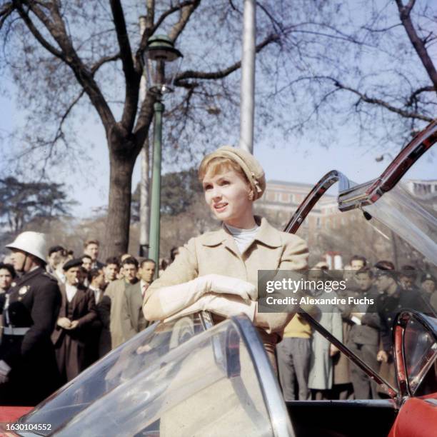 Actress Debbie Reynolds enters a car for a scene of the film ‘It Started With A Kiss’ in 1958 in Madrid, Spain.