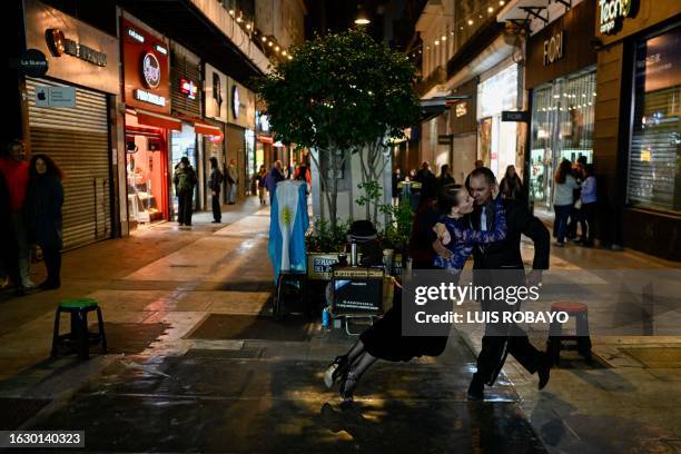 Couple dances tango in a street of Buenos Aires on August 28, 2023. The Tango World Festival and Championship, which brings together thousands of...