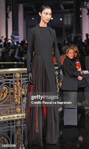 Model walks the runway during the John Galliano Fall/Winter 2013 Ready-to-Wear show as part of Paris Fashion Week at Le Centorial on March 3, 2013 in...