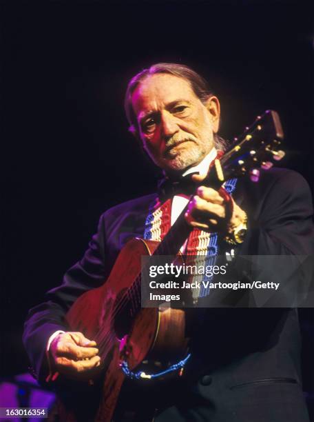 American country musician Willie Nelson, in formal attire, performs during a Valentine's Day concert at the Beacon Theater, New York, New York,...