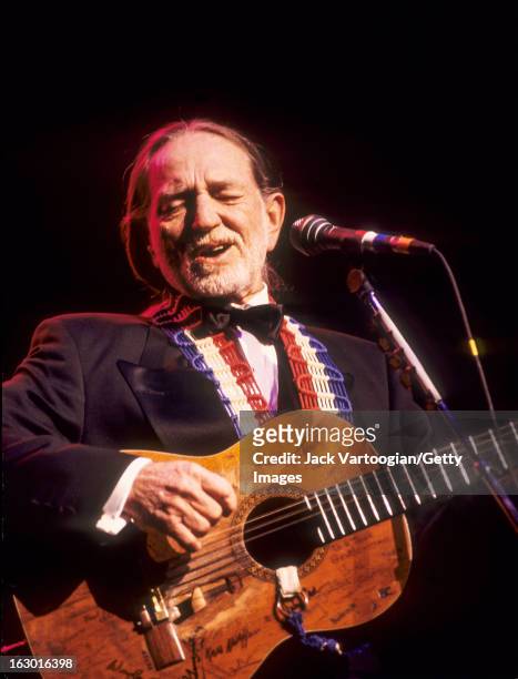 American country musician Willie Nelson, in formal attire, performs during a Valentine's Day concert at the Beacon Theater, New York, New York,...
