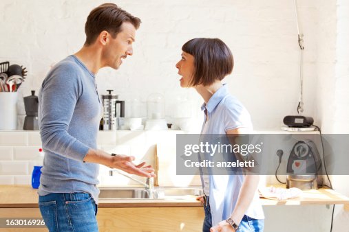 Kitchen Discussion Couple Having A Discussion In The Kitchen High-Res Stock Photo - Getty ...
