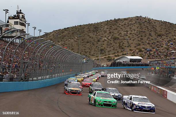 Mark Martin, driver of the Aaron's Dream Machine Toyota, and Kasey Kahne, driver of the Quaker State Chevrolet, lead the first lap during the NASCAR...