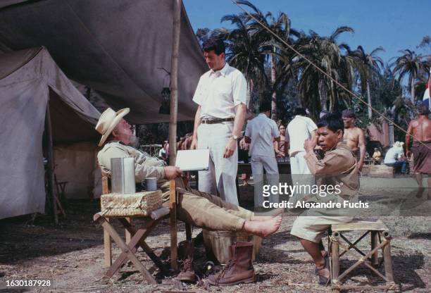 Actors Rock Hudson, Burl Ives and Ibrahim Pendek talking while at the set of the film 'The Spiral Road' at Suriname in 1961.