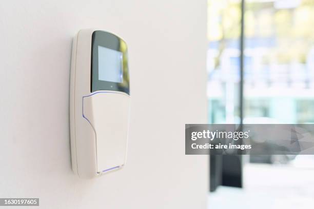 one fire and burglary alarm panel, black and white plastic intercom with a small screen with a blurred background. - sensor data stock pictures, royalty-free photos & images
