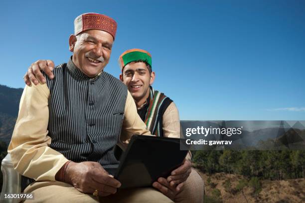 people of himachal pradesh: grandson and grandfather with laptop - kurta stock pictures, royalty-free photos & images