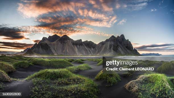 vestrahorn mountain at stokksnes peninsula with the black sand dunes in the foreground, hornafjordur (hornafjörður, höfn), south east iceland. - volcanic landscape stock pictures, royalty-free photos & images