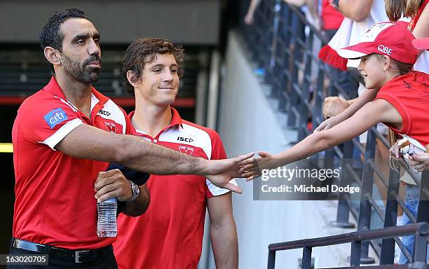 Adam Goodes and Kurt Tippett of the Sydney Swans acknowledge a supporter during the round two AFL NAB Cup match between the St Kilda Saints and the...