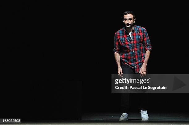 Fashion designer Riccardo Tisci acknowledges applause foolowing the Givenchy Fall/Winter 2013 Ready-to-Wear show as part of Paris Fashion Week on...