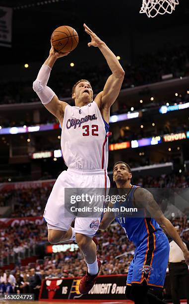 Blake Griffin of the Los Angeles Clippers dunks over Thabo Sefolosha of the Oklahoma City Thunder at Staples Center on March 3, 2013 in Los Angeles,...