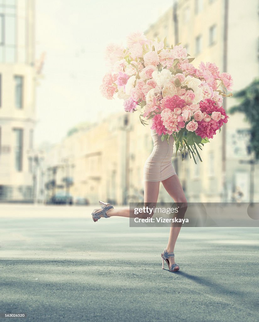 Running women with giant bunch of flowers