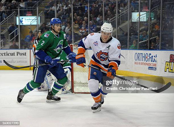 Dylan McIlrath of the Connecticut Whale skates against Scott Campbell of the Bridgeport Sound Tigers during an American Hockey League game on March...