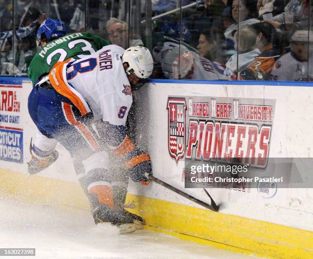 Nathan McIver of the Bridgeport Sound Tigers checks Brandon Mashinter of the Connecticut Whale during an American Hockey League game on March 3, 2013...