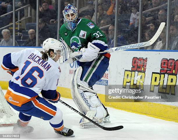 Cameron Talbot of the Connecticut Whale clears the puck past Sean Backman of the Bridgeport Sound Tigers during an American Hockey League game on...