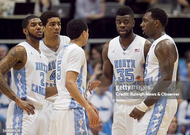North Carolina's Reggie Bullock huddles with teammates Leslie McDonald , James Michael McAdoo , Marcus Paige and P.J. Hairston in the first half...