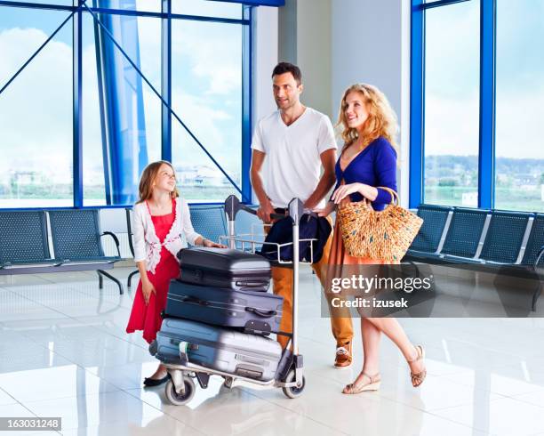 happy family at the airport - luggage trolley stock pictures, royalty-free photos & images