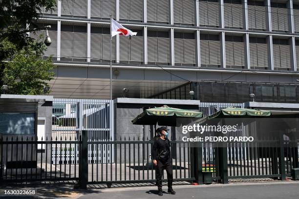 Police and security personnel stand outside the entrance of the Japanese embassy in Beijing on August 29, 2023. Japan said on August 29 that...