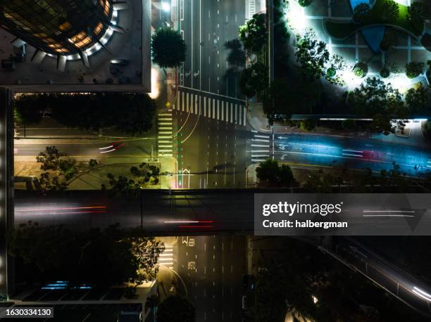 top down drone shot of 4th st & figueroa in downtown la at night - downtown los angeles stock pictures, royalty-free photos & images