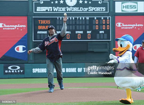 In this handout photo provided by Disney Parks, Jarvis Jones throws out the first pitch with Donald Duck before an Atlanta Braves spring training...