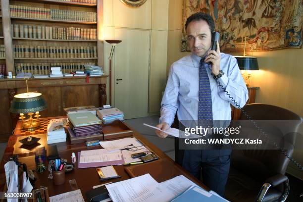 Rendezvous With Jean-Francois Cope At Bercy. Attitude souriante de Jean-François COPE debout à son bureau de Bercy à PARIS, un téléphone dans une...