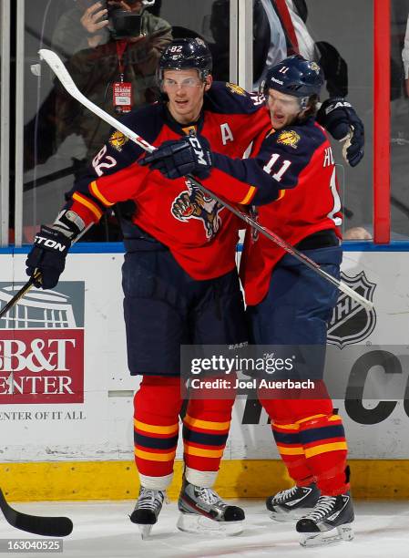 Jonathan Huberdeau is congratulated by Tomas Kopecky of the Florida Panthers after he scored a third period goal against the Carolina Hurricanes at...