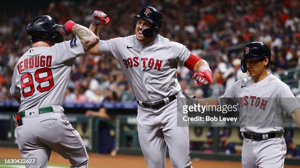 Adam Duvall of the Boston Red Sox celebrates his three-run home run with Alex Verdugo and Masataka Yoshida in the first inning against the Houston...